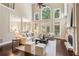 Spacious living room with fireplace, high ceilings, large windows, and hardwood floors at 110 Wellington Way, Canton, GA 30115