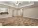 Open-concept living room showcasing beautiful wood floors and a bar-like pass-through at 110 Wellington Way, Canton, GA 30115