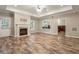 Spacious living room featuring a fireplace, wood floors, and a pass-through bar area at 110 Wellington Way, Canton, GA 30115