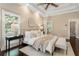 Inviting main bedroom showcasing a tray ceiling, hardwood floors, and ample natural light at 110 Wellington Way, Canton, GA 30115