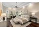 Serene main bedroom featuring a tray ceiling, hardwood floors, and a sitting area at 110 Wellington Way, Canton, GA 30115