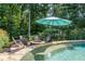 Outdoor pool with chairs sitting in the water and a fire pit surrounded by seating area at 110 Wellington Way, Canton, GA 30115