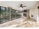 Inviting sun room with a stone fireplace, ceiling fan, tile floors, and lots of natural light at 110 Wellington Way, Canton, GA 30115