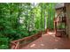 Large wooden deck backing up to a private treed yard offers an extension of outdoor living space at 313 Clubhouse Nw Ct, Kennesaw, GA 30144