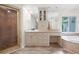 Bright bathroom featuring a vanity with storage, shower with glass door, and jacuzzi tub next to a window at 313 Clubhouse Nw Ct, Kennesaw, GA 30144