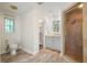 Bright bathroom featuring a toilet, vanity with storage, and shower with glass door at 313 Clubhouse Nw Ct, Kennesaw, GA 30144