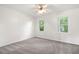Bright bedroom featuring neutral walls and carpet, and windows with views of wooded landscape at 313 Clubhouse Nw Ct, Kennesaw, GA 30144
