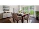 Formal dining room featuring elegant furnishings, including a sophisticated dining table, chairs, and ample natural light at 313 Clubhouse Nw Ct, Kennesaw, GA 30144