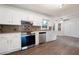 Bright kitchen features white cabinets, stainless steel appliances, and a decorative backsplash at 313 Clubhouse Nw Ct, Kennesaw, GA 30144