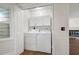 Convenient laundry area tucked behind doors with washer, dryer, and extra storage at 313 Clubhouse Nw Ct, Kennesaw, GA 30144