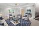 Living room featuring a sofa, accent chairs, and a glass table on a blue rug at 313 Clubhouse Nw Ct, Kennesaw, GA 30144