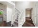 Bright stairway with carpeted steps, white railing, and an inviting view of the entryway at 313 Clubhouse Nw Ct, Kennesaw, GA 30144