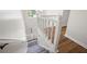 Elegant staircase featuring white railings and a combination of carpet and hardwood floors at 313 Clubhouse Nw Ct, Kennesaw, GA 30144