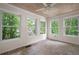Cozy sunroom with brick floors, wood ceiling, and large windows overlooking the greenery at 313 Clubhouse Nw Ct, Kennesaw, GA 30144