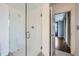 Modern bathroom showcasing a glass-enclosed shower with marble-style walls and an adjacent door at 3481 Lakeside Ne Dr # 1107, Atlanta, GA 30326