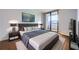 Nicely staged bedroom with a large comfortable bed, stylish decor, and a view of the outdoors at 3481 Lakeside Ne Dr # 1107, Atlanta, GA 30326