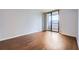 Bright bedroom with hardwood floors and sliding glass doors leading to a balcony at 3481 Lakeside Ne Dr # 1107, Atlanta, GA 30326