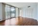 Bright bedroom featuring hardwood floors, large windows with a view, and ample closet space at 3481 Lakeside Ne Dr # 1107, Atlanta, GA 30326
