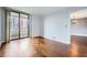 Inviting bedroom with gleaming wood floors and sliding doors that lead to a balcony with city views at 3481 Lakeside Ne Dr # 1107, Atlanta, GA 30326