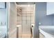 Laundry area featuring white appliances, shelving, and a louvered door at 3481 Lakeside Ne Dr # 1107, Atlanta, GA 30326