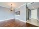 Open-concept living space featuring a crystal chandelier and hardwood floors at 3481 Lakeside Ne Dr # 1107, Atlanta, GA 30326
