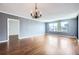 Spacious living room with hardwood floors, chandelier, and large windows providing plenty of natural light at 3481 Lakeside Ne Dr # 1107, Atlanta, GA 30326