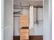 Organized walk-in closet featuring wooden drawers and metal shelving for storage at 3481 Lakeside Ne Dr # 1107, Atlanta, GA 30326