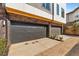 Two-car garage with dark gray doors and brick accents in a modern townhome at 1237 Memorial Se Dr # 402, Atlanta, GA 30316