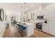 Modern kitchen with white cabinets, stainless steel appliances, island with seating, and hardwood flooring at 1237 Memorial Se Dr # 402, Atlanta, GA 30316