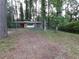 Charming single story home with a brick facade and covered parking nestled in a wooded lot at 3252 Pinehill Dr, Decatur, GA 30032