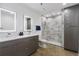 Bathroom featuring double sink vanity, illuminated mirrors, and a gray tiled walk-in shower at 505 Whitehall Sw St # 102, Atlanta, GA 30303