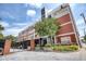 Building exterior with mature landscaping, gated parking, and clearly marked addresses at 505 Whitehall Sw St # 102, Atlanta, GA 30303