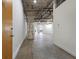 Hallway leading to living space with exposed pipes and concrete floors at 505 Whitehall Sw St # 102, Atlanta, GA 30303