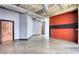 Hallway features a concrete floor, an exposed ceiling, and a red accent wall at 505 Whitehall Sw St # 102, Atlanta, GA 30303