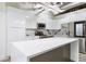 Modern kitchen with a large island, white cabinets, stainless steel appliances, and white marble backsplash at 505 Whitehall Sw St # 102, Atlanta, GA 30303