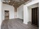 Open living room featuring exposed ceilings, wood floors, and ample natural light at 505 Whitehall Sw St # 102, Atlanta, GA 30303