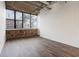 Empty living room with wood floors, exposed ceilings, and a large window at 505 Whitehall Sw St # 102, Atlanta, GA 30303