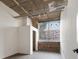 Living room with exposed ceilings, brick accent wall, and large windows with blinds at 505 Whitehall Sw St # 102, Atlanta, GA 30303