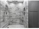 Walk-in shower featuring gray marble tile, a rainfall shower head, and built-in shelving at 505 Whitehall Sw St # 102, Atlanta, GA 30303