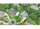 Aerial view of two homes in a lush neighborhood surrounded by mature trees and landscaping at 5980 Whitestone Ln, Suwanee, GA 30024