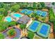 Community clubhouse with pool, tennis courts, lounge chairs surrounded by trees at 5980 Whitestone Ln, Suwanee, GA 30024