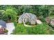 Aerial view of a traditionally styled home with mature landscaping and a winding front walkway at 5980 Whitestone Ln, Suwanee, GA 30024