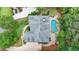 Aerial view of a home and backyard pool with mature trees and landscaping at 5980 Whitestone Ln, Suwanee, GA 30024