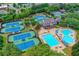 Community aerial view showcasing a pool, a clubhouse, and impeccably maintained tennis courts at 5980 Whitestone Ln, Suwanee, GA 30024
