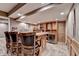 The wet bar features a counter with seating, built-in shelving, and a small refrigerator at 5980 Whitestone Ln, Suwanee, GA 30024
