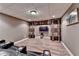 Finished basement with a theater featuring tiered leather seats and a large flat-screen TV at 5980 Whitestone Ln, Suwanee, GA 30024