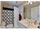 Bathroom featuring a toilet, shower with a curtain, and a sink vanity at 5980 Whitestone Ln, Suwanee, GA 30024