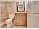 Bathroom featuring a tiled shower, vanity with granite counters, and tile flooring at 5980 Whitestone Ln, Suwanee, GA 30024