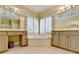 Bathroom featuring a corner tub, double vanity, mirrors and tile flooring at 5980 Whitestone Ln, Suwanee, GA 30024