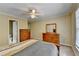 Bedroom with a ceiling fan, window with blinds, and wooden dresser furniture at 5980 Whitestone Ln, Suwanee, GA 30024